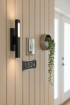 Baldwin Rectangular Doorbell Button Chrome on modern light-colored entry wall board with minimalist hardware