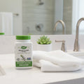 Nature's Way Skullcap Herb bottle on white quartz bathroom vanity with cotton face towel and small succulent