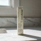 Cocokind Beginner Retinol Gel cream-colored box on clean white marble bathroom counter, soft natural morning light