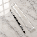 AI-generated lifestyle photo of the Mary Kay Dual-Ended Eye Definer and Eye Crease Brush on a vanity countertop with its travel sleeve