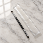 AI-generated lifestyle photo of the Mary Kay Dual-Ended Eye Definer and Eye Crease Brush on a vanity countertop with its travel sleeve