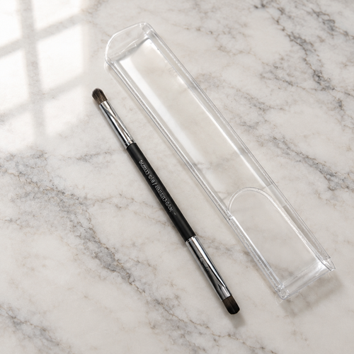 AI-generated lifestyle photo of the Mary Kay Dual-Ended Eye Definer and Eye Crease Brush on a vanity countertop with its travel sleeve