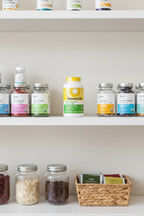Renew Life Prebiotic Fiber on organized white apothecary shelf with glass supplement containers and pantry items
