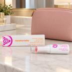 Mary Kay at Play Triple Layer Tinted Balm tube and box beside a blush cosmetic pouch