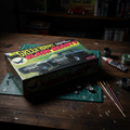Polar Lights Green Hornet Black Beauty 1/32 scale model kit box on wooden hobby desk next to model glue and paint brushes classic TV car collector lifestyle