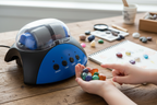 Child holding colorful polished gemstones from Maxx Explore Rock Tumbler geology kit STEM toy