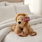 Russ Jazwares 14 inch Lion Plush displayed as gift on white bedding with ribbon - More4less Outlet