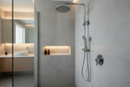 Luxury chrome shower fixture installed in a tiled modern bathroom interior
