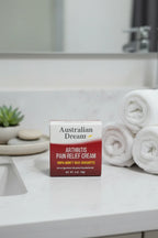 Australian Dream Arthritis Pain Relief Cream on quartz bathroom vanity with rolled towels and ceramic tray — More4less Outlet