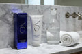 ZO Skin Health Hydrating Cleanser 6.7oz displayed on a minimalist white marble vanity with glass water carafe and rolled white towel