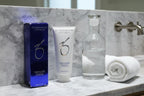 ZO Skin Health Hydrating Cleanser 6.7oz displayed on a minimalist white marble vanity with glass water carafe and rolled white towel
