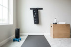 Active recovery home gym setup with SLF Cryosleeve compression sleeve on yoga mat