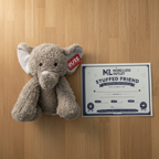 Russ Jazwares Elephant Plush next to More4less Outlet Stuffed Friend Adoption Certificate gift flat lay - More4less Outlet