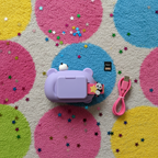 Flat lay of Vivitar Kids Tech Kidzcam Camcorder purple panda with memory card USB lanyard and star confetti on colorful rug