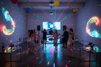Festive party atmosphere with colorful rotating LED light accents reflecting multicolor patterns on walls