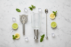 Houdini 4-Piece Cocktail Tool Set flat lay on white marble with citrus and ice styling - More4less Outlet