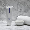 ZO Medical Vitascrub on gray granite bathroom counter with white towel and porcelain bowl