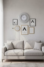 Ingraham 12 inch Silver Glitter Wall Clock mounted above gray living room sofa with wall art — More4less Outlet