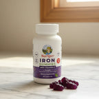 Mary Ruth's Iron Gummies bottle on marble countertop with grape gummies lifestyle image