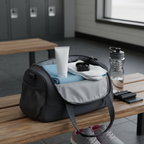 Open gym bag with travel-size skincare tube neatly tucked inside on a locker room bench