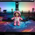 Stumble Guys Pink Cat Plush Buddy displayed on a gaming desk with LED lighting - More4less Outlet