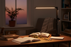 Room and Retreat 16-inch black LED desk lamp illuminated on student desk with textbooks in cozy bedroom study