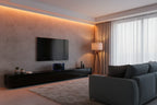 Modern living room entertainment area highlighting compact black wireless speaker system with subwoofer