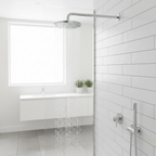 Modern bathroom with white subway tiles and polished chrome showerhead spraying water