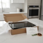 Lifestyle — black glass kitchen scale in gift box with white tissue paper and recipe card on white kitchen counter — gifting editorial for visual context only