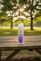 OFF! Clean Feel Insect Repellent spray bottle on wooden picnic table with green trees and sunlight