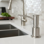 Close-up macro of Kohler architectural kitchen plumbing hardware in a modern culinary workspace