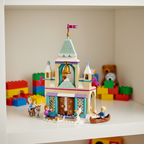 LEGO Disney Frozen Arendelle Frozen Castle set 43265 — colorful built multi-level castle with teal and gold tower, opening front doors, golden bell, and snowy winter details on a bright white children's playroom shelf