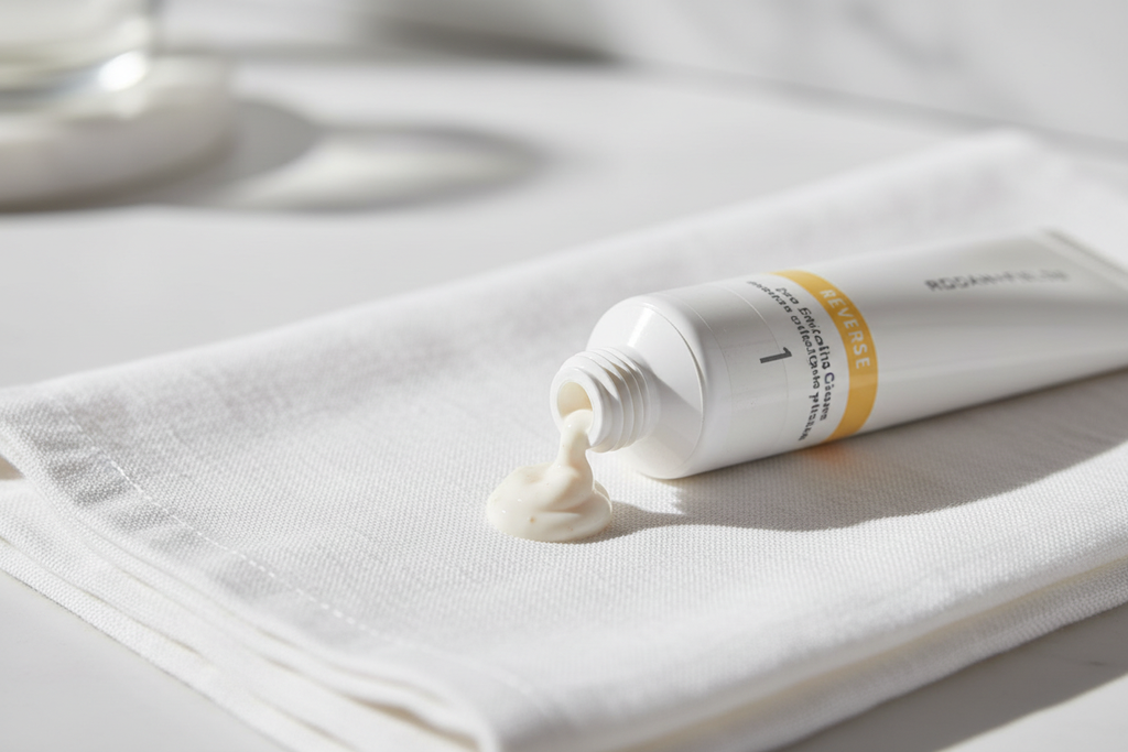 Macro shot of Rodan + Fields REVERSE exfoliating cleanser cream texture on white linen