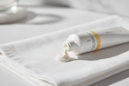 Macro shot of Rodan + Fields REVERSE exfoliating cleanser cream texture on white linen