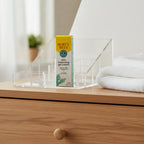 Burt's Bees Skin Balancing Gel Cream box in acrylic cosmetic display on light-oak dresser near soft white cotton towel