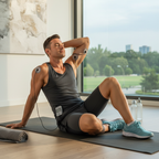 Person post-workout with TENS electrode pads on shoulder and upper arm for muscle recovery