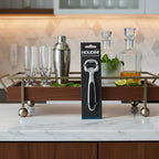 Houdini by Rabbit bottle opener on stylish home bar cart with contemporary bar accessories.