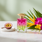 Lifestyle image — vibrant pink and green perfume bottle on white marble beside fresh passionfruit and tropical flowers, bright editorial beauty for visual context only