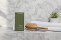 KEVIN.MURPHY MAXI.WASH on marble bathroom shelf with brush and towel lifestyle