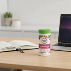 Rainbow Light Women's One Multivitamin bottle on modern office desk with open premium planner and laptop