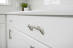 Baldwin Couture 4-inch cabinet pull satin nickel installed on white shaker kitchen cabinet drawer - More4less Outlet