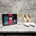 Glitter Flask Gift Set open on white bridal suite table next to elegant wedding heels and champagne glass