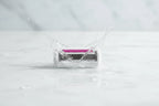 Close-up of water splashing over a high-quality 5-blade women's razor refill cartridge on white marble