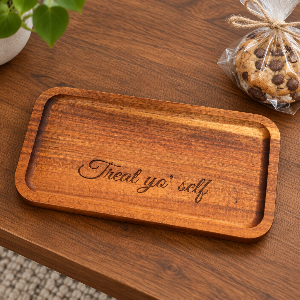 Treat Yo' Self engraved wood tray on a table beside a wrapped cookie
