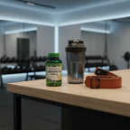 Nature's Truth L-Arginine HCl 1000mg bottle on wooden home gym counter with black matte shaker bottle and lifting straps