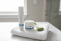 Rodan + Fields REDEFINE Triple Defense 3AM set lotion bottle and cream jar on marble vanity with jade roller and white towel morning skincare – More4less Outlet