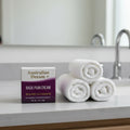 Australian Dream Back Pain Cream 4 oz on gray slate bathroom vanity with rolled cotton towels