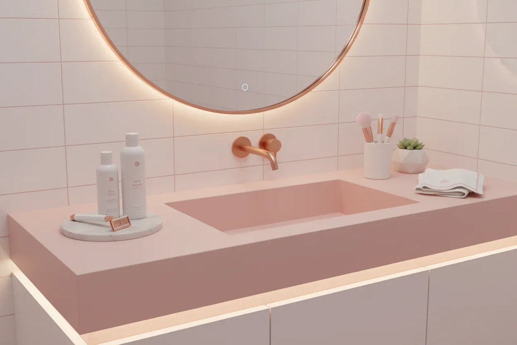 Minimalist pink and white bathroom vanity showing premium women's shaving tools and grooming essentials