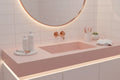 Minimalist pink and white bathroom vanity showing premium women's shaving tools and grooming essentials