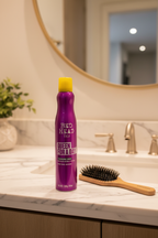 Bed Head TIGI Queen For A Day spray on marble bathroom vanity with mirror and brush